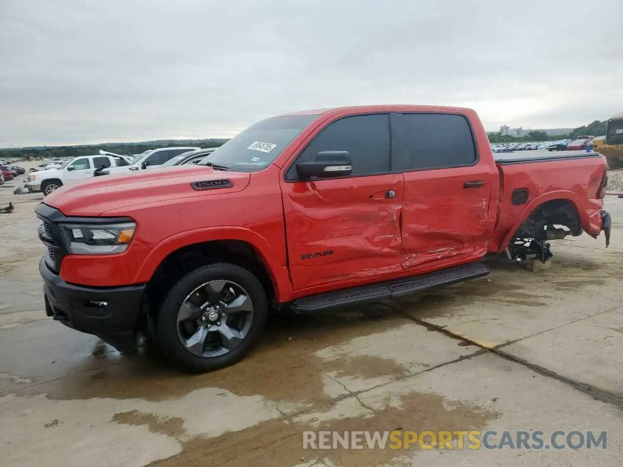 1 Photograph of a damaged car 1C6SRFFT8MN704711 RAM 1500 2021